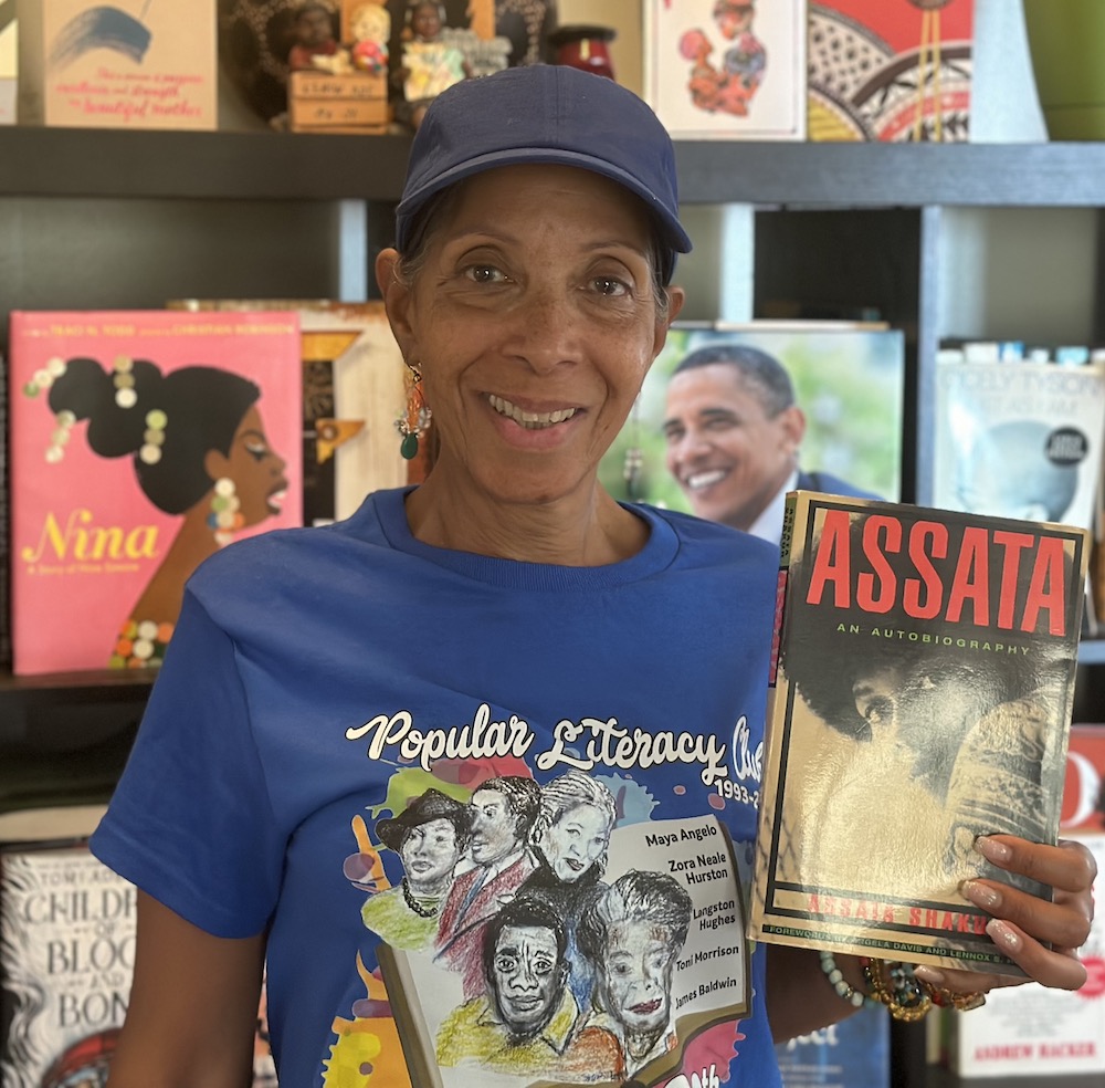 Soror Grant holding copy of Assata